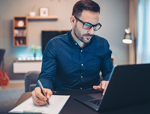 Young man using computer in home office