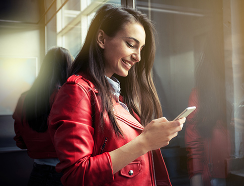 Young woman using phone in public setting