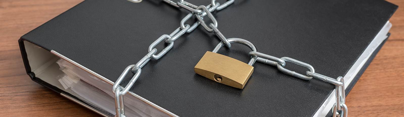 a black binder with a chain and pad lock on it